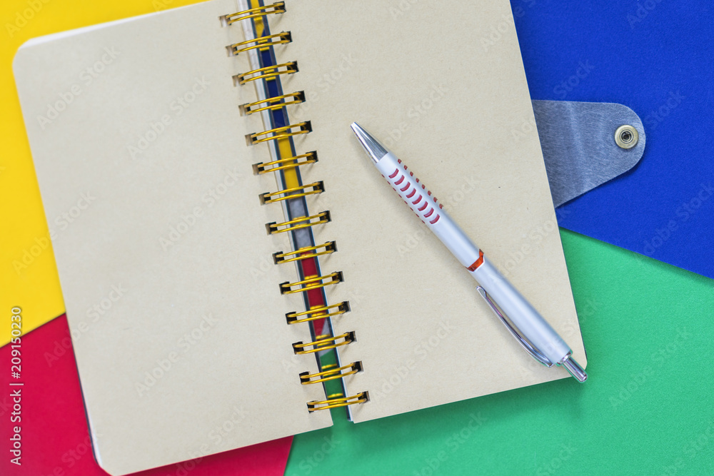 Open notebook on colorful bright paper, background with copy space for text. Top view. Concept of starting school, education, handmade creative Open notebook on colorful bright paper, background with copy space for text. Top view. Concept of starting school, education, handmade creative