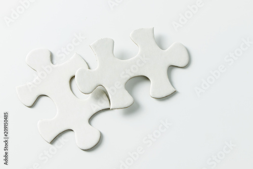 Two pieces of blank white jigsaw puzzle isolated on white background for business conceptual