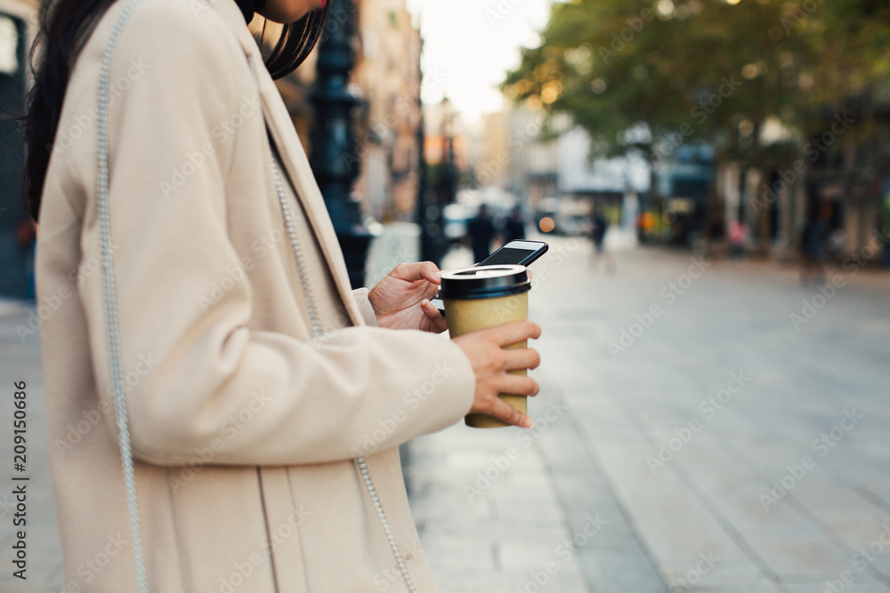 Stylish woman in the city using mobile phone. Stylish woman in the city using mobile phone.
