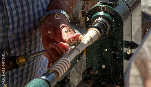 hand of a man using a tool to process wood