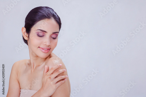 A young Asian woman portrait. She skin care image on white background . She is very happy and She smiles. Photo concept woman Portrait and skin care.