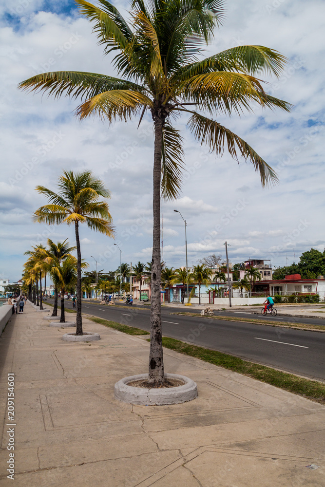 CIENFUEGOS, CUBA - FEBRUARY 11, 2016: View of Malecon (seaside drive) in Cienfuegos, Cuba. CIENFUEGOS, CUBA - FEBRUARY 11, 2016: View of Malecon (seaside drive) in Cienfuegos, Cuba.