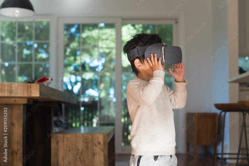 Kid playing with virtual reality glasses at home Kid playing with virtual reality glasses at home