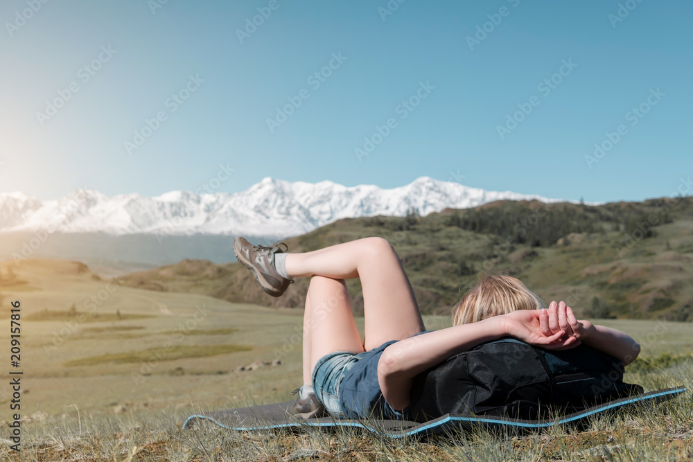 successful woman backpacker enjoy the view on mountain peak.