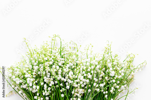 Small and fragrant spring flowers. Bouqet of lily of the valley flowers on white background top view copy space