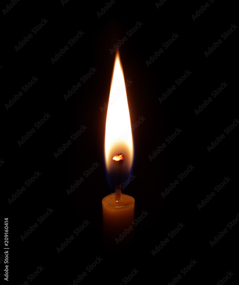 candle burning brightly in the black background candle burning brightly in the black background