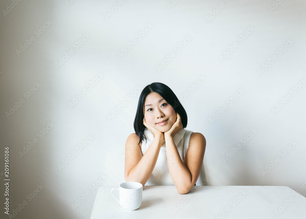 Portrait of young woman in minimalist setting looking at camera Portrait of young woman in minimalist setting looking at camera
