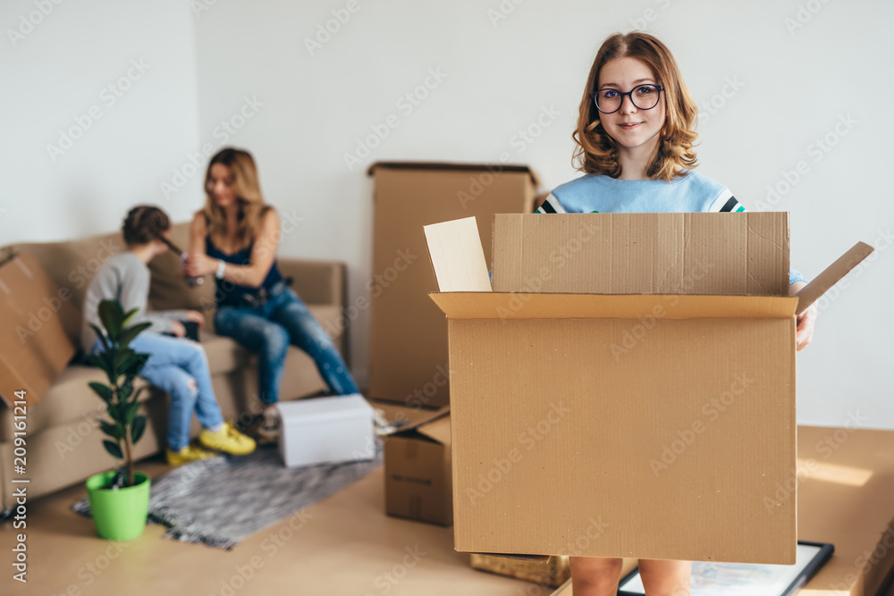 Family unpacking cardboard boxes at new home Family unpacking cardboard boxes at new home