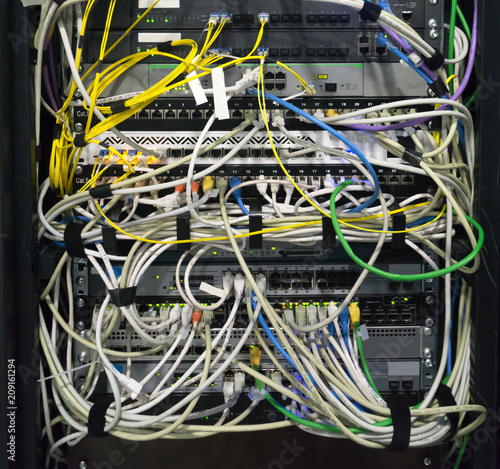 Detail of a communications rack, fiber, internet, network, switc photo