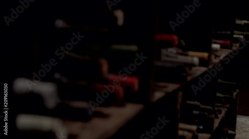 Old vintage wine bottles in dark wine cellar close up Australia
