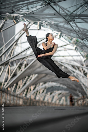 Beautiful Young Girl Dancing on a bridge