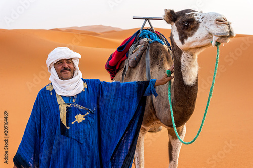Portrait of a Berber and camel in the Sahara Desert