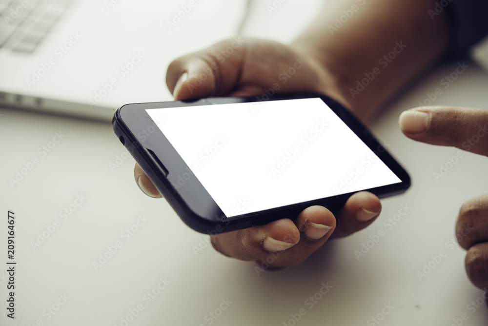 hands holding blank screen mobile in desk work. hands holding blank screen mobile in desk work.