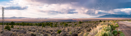 Rio Grande Gorge at Sunset with Dramatic Cloudscape and Taos Mountains in the Background. photo