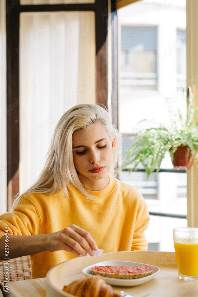 Woman eating toast with jam Woman eating toast with jam