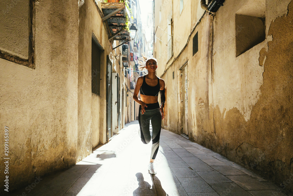 Young latin woman running on the street. Urban life. Young latin woman running on the street. Urban life.