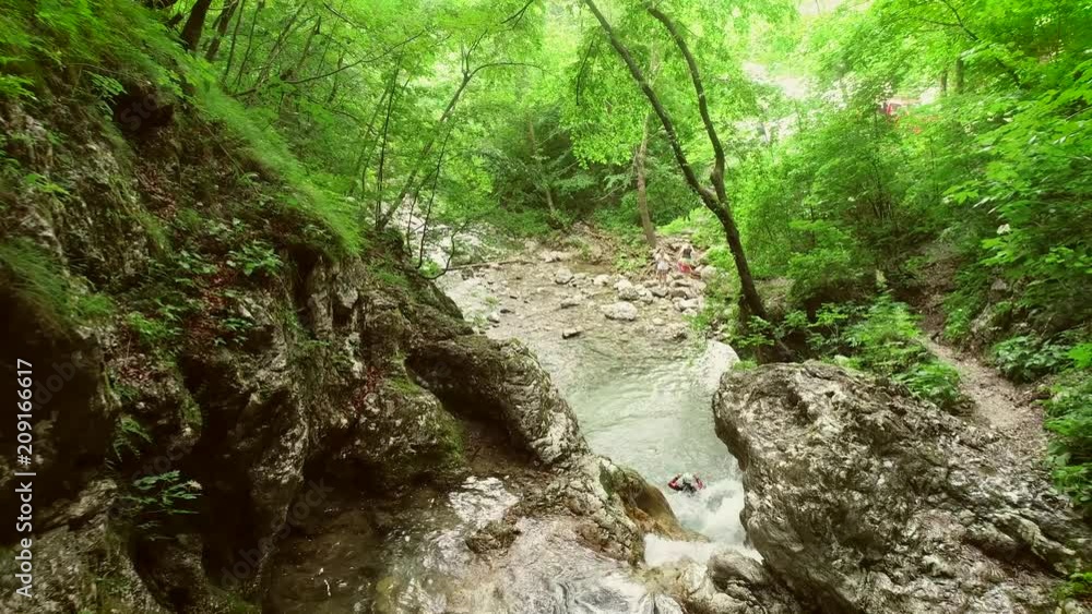 Aerial view of couple jumping in sliding rock at Soca river, Slovenia. Aerial view of couple jumping in sliding rock at Soca river, Slovenia.