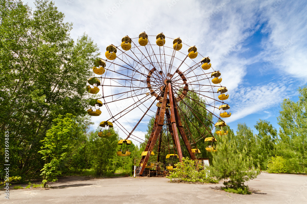 The abandoned Ferris wheel in the amusement park in a dead city Pripyat, Ukraine. Chernobyl nuclear power plant zone of alienation