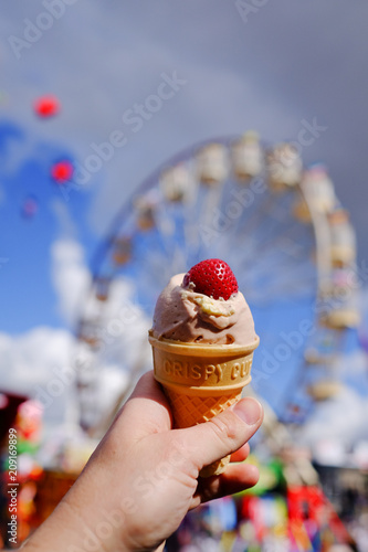 Famous Strawberry Ice Cream with rides in the background at the Ekka (Brisbane Exhibition or Royal Queensland Show), Brisbane, Australia
