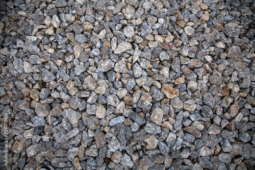 Close-up of gray stones of different sizes on the floor in the old town, background