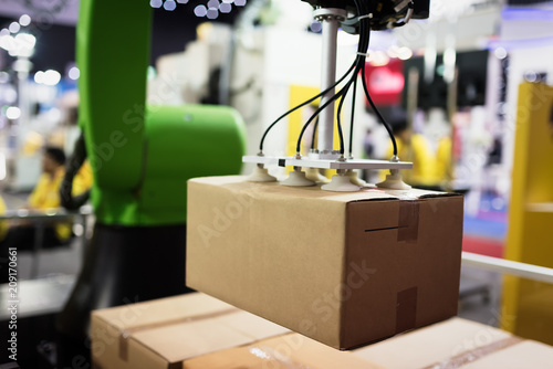 Automatic hand hold the cardboard box at factory in Thailand.