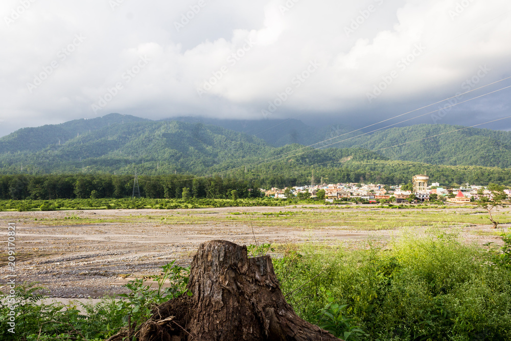 bare land with mountains at the distance because of deforestation