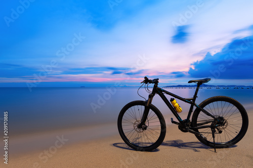 Black bicycle on the beach at sunset in Pattaya,Thailand.