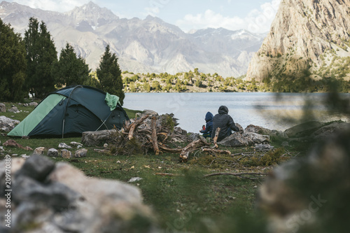 family camping beside mountain lake photo