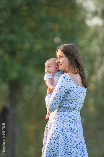 Portrait of young mother holding dearly her newborn child