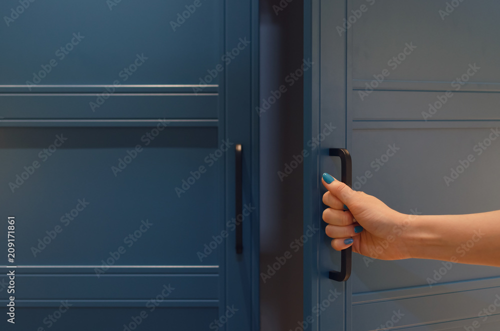 Women hand open a wardrobe cabinet. Women hand open a wardrobe cabinet.