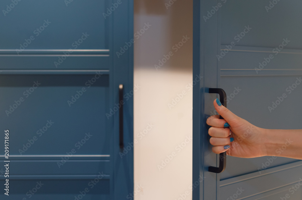 Women hand open a wardrobe cabinet. Women hand open a wardrobe cabinet.