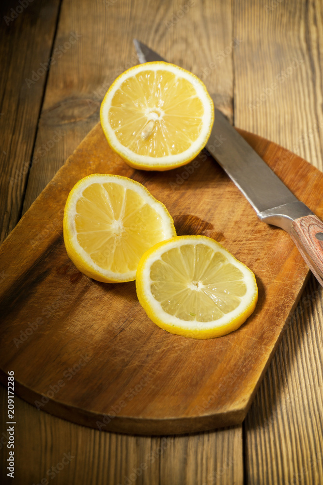 cut lemon on a cutting board with a knife cut lemon on a cutting board with a knife