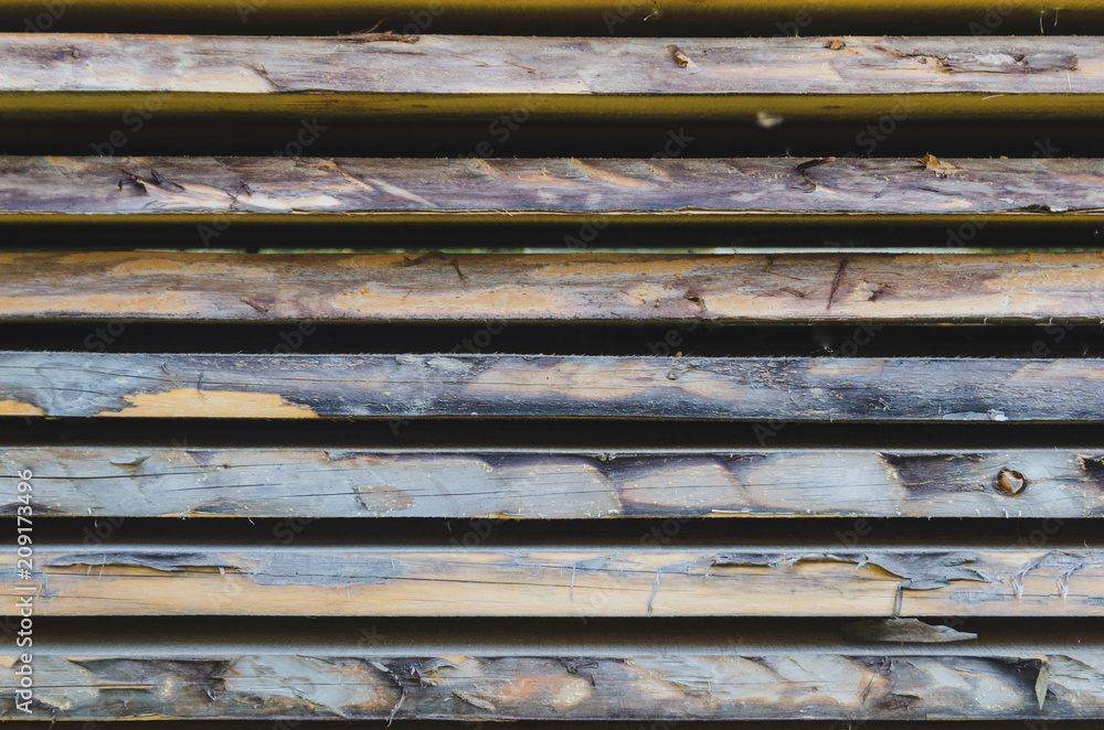 Old stacked weathered wooden boards