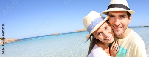 Happy couple walking in crystal clear sea water, template