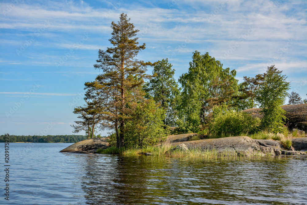 Islands in the North of the Leningrad region on lake Vuoksa. Sunny morning on the water.
