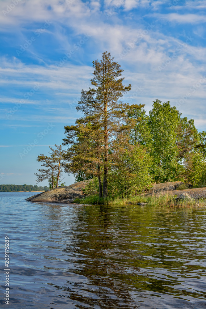 Islands in the North of the Leningrad region on lake Vuoksa. Sunny morning on the water. Islands in the North of the Leningrad region on lake Vuoksa. Sunny morning on the water.