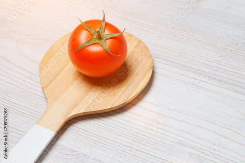 tomato on white wooden background