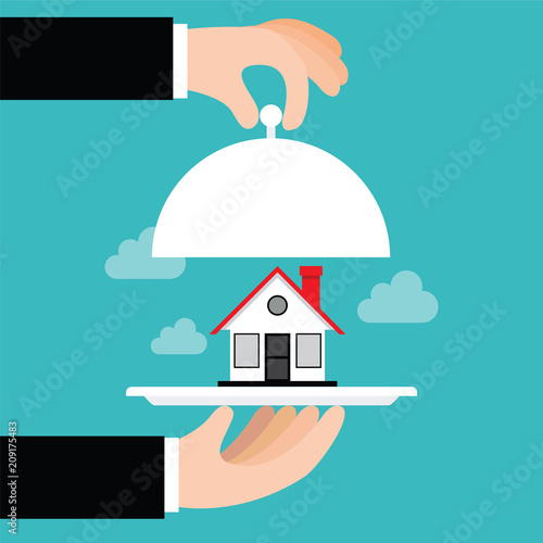 Hand opens serve cloche with house inside