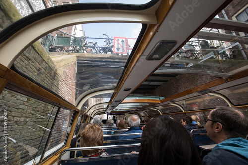 Photography A tourboat is taking tourists around the canals in Amsterdam