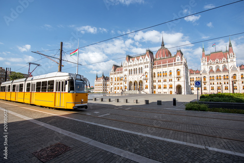 Parliamen tbuilding with yellow tram on the central square in Budapest city, Hungary