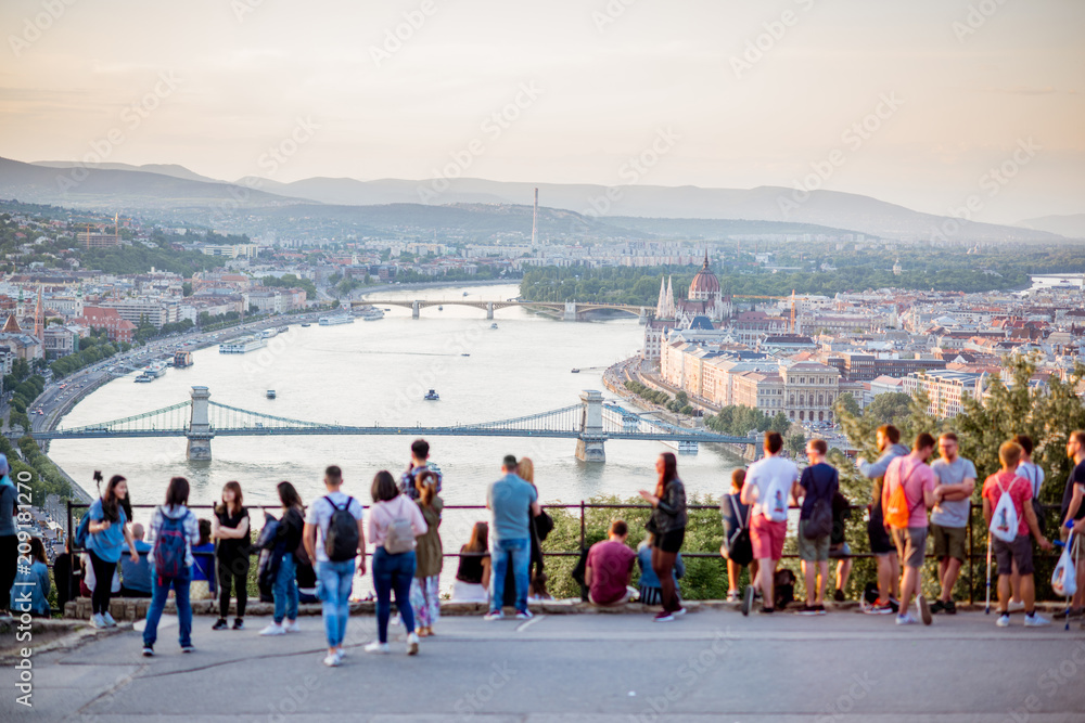 Naklejka premium People enjoying great view on Budapest city with Danube river and bridge during the sunset in Hungary. People is out of focus