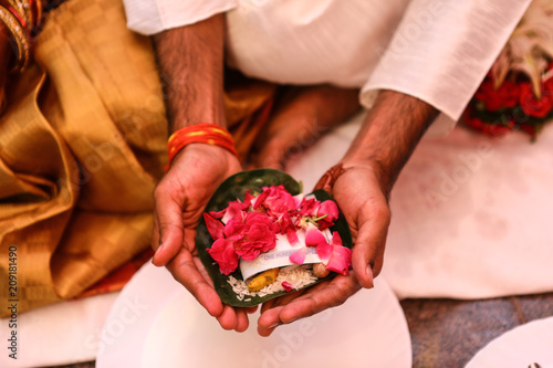 Canvas Print Photo showing Groom offering Pan and Flowers, a ritual in Hindu wedding