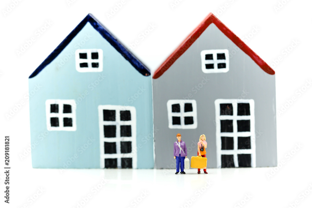 Miniature people : Couple of love standing with Piggy bank with house and stack of coins,Saving to buy a house, real estate or home savings concept. Miniature people : Couple of love standing with Piggy bank with house and stack of coins,Saving to buy a house, real estate or home savings concept.