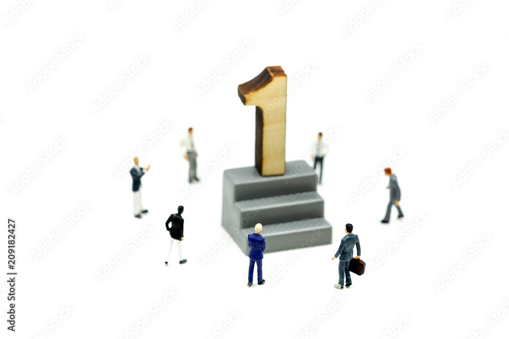 Miniature people : Businessman standing with wooden number of 1,to be the first,Business competition Concept. Miniature people : Businessman standing with wooden number of 1,to be the first,Business competition Concept.