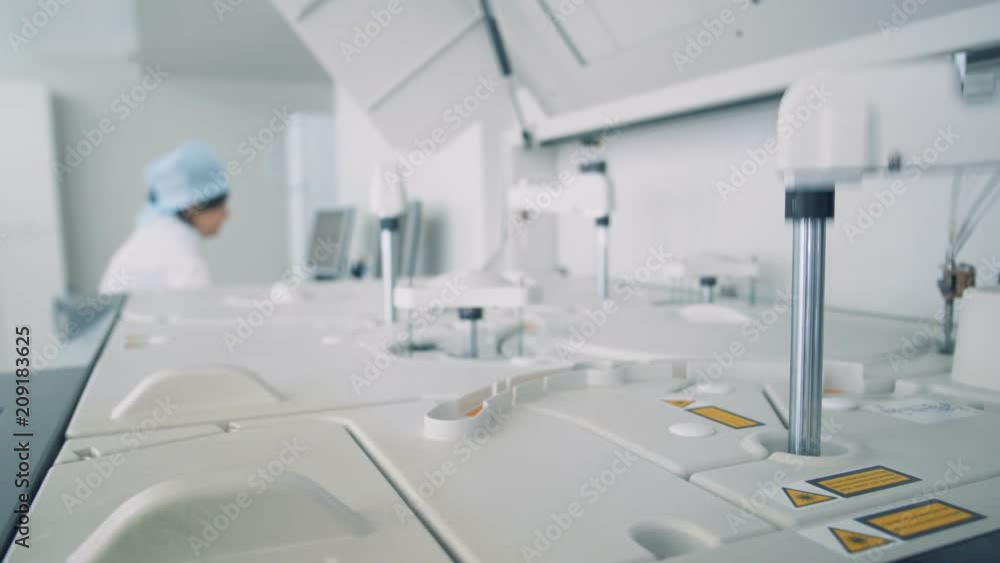 Special devices work in modern laboratory, while scientists working with computers. Special devices work in modern laboratory, while scientists working with computers.