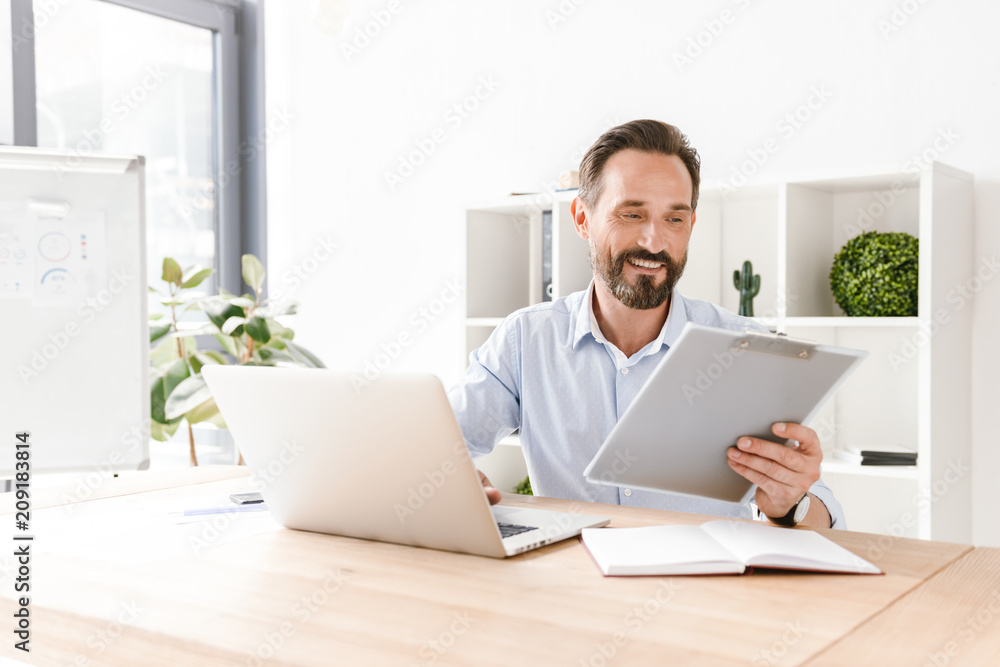 Excited businessman holding folder Excited businessman holding folder