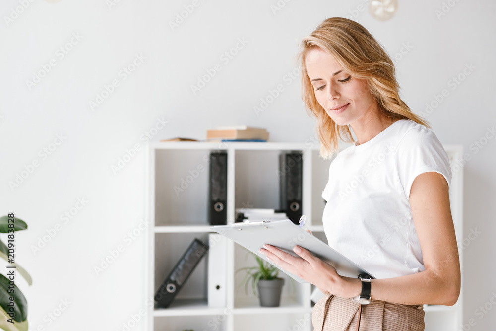 Smart businesswoman analyzing documents Smart businesswoman analyzing documents