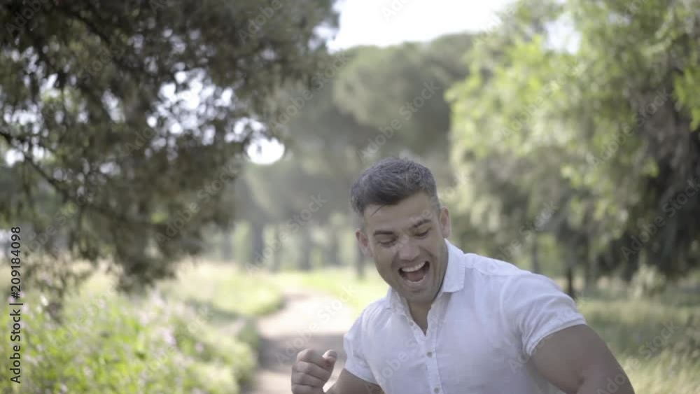 Handsome European man holding mobile smart phone with surprised face emotionally showing success. Handsome European man holding mobile smart phone with surprised face emotionally showing success.