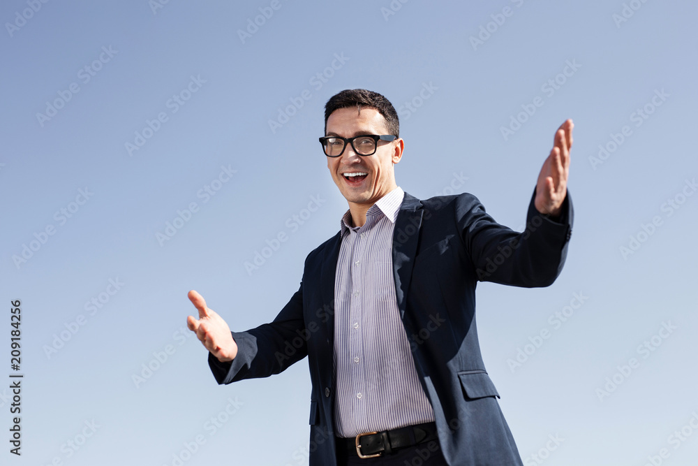 Laughing man. Laughing handsome career man feeling extremely satisfied after important business meeting Laughing man. Laughing handsome career man feeling extremely satisfied after important business meeting