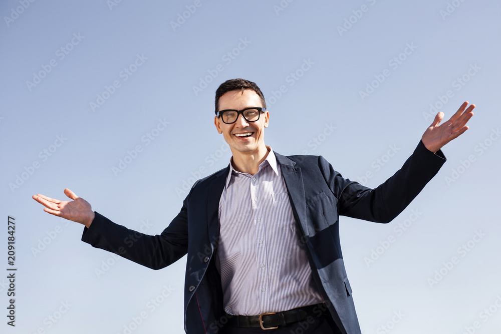 Striped shirt. Prosperous businessman wearing stylish striped shirt smiling broadly after getting promotion Striped shirt. Prosperous businessman wearing stylish striped shirt smiling broadly after getting promotion